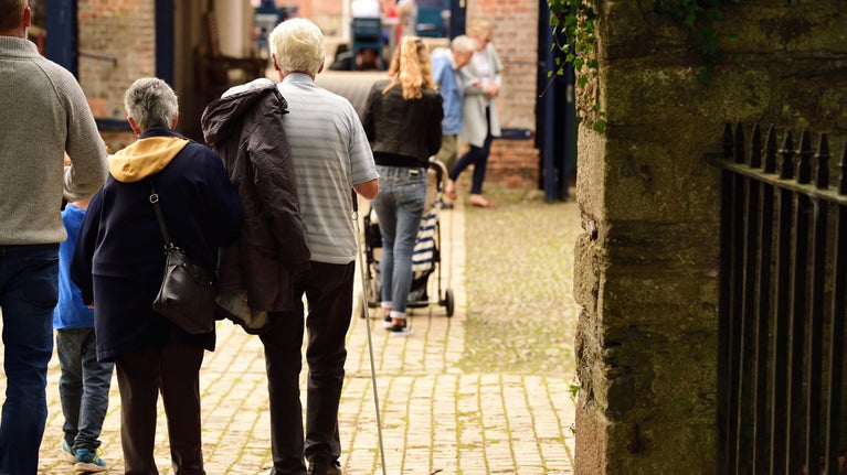 Visitors walking through the archway at Saltram